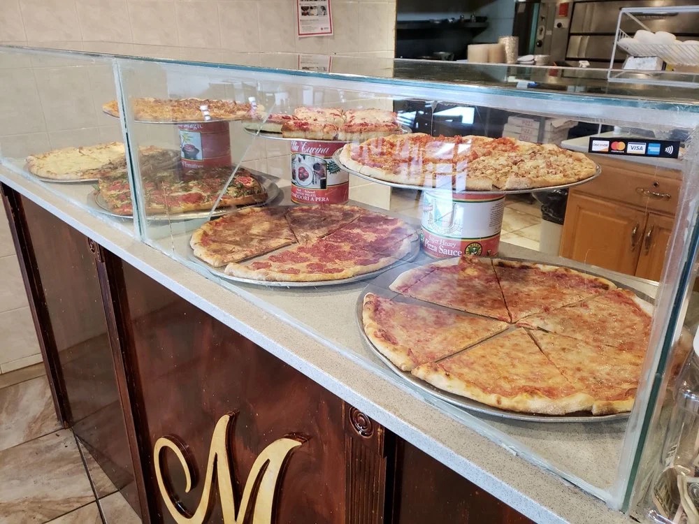 Fresh pies in the case at Three Brothers Pizza